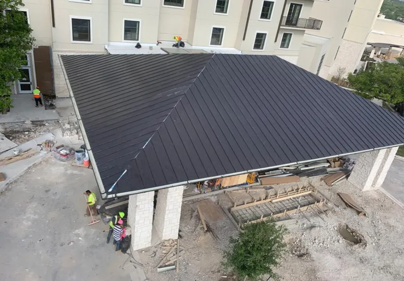Metal roofing installation team working on a commercial building in Cottonwood